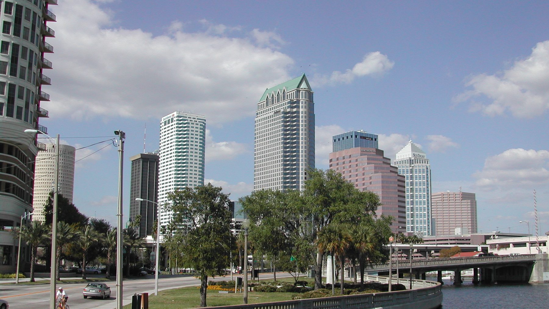 Skyline of Tampa from Bayshore Boulevard -- the balustrade curving along the bay, downtown towers (Rivergate’s green-capped crown, SunTrust/Wells Fargo, Bank of